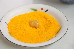Coat with Breadcrumbs Take the marinated chicken pieces and roll them in the breadcrumbs one by one. Press gently to ensure the crumbs adhere well.