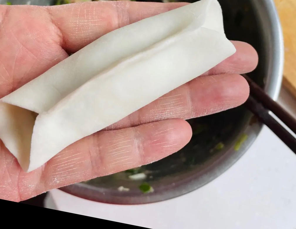 Bring the top and bottom edges of the wrapper together over the filling