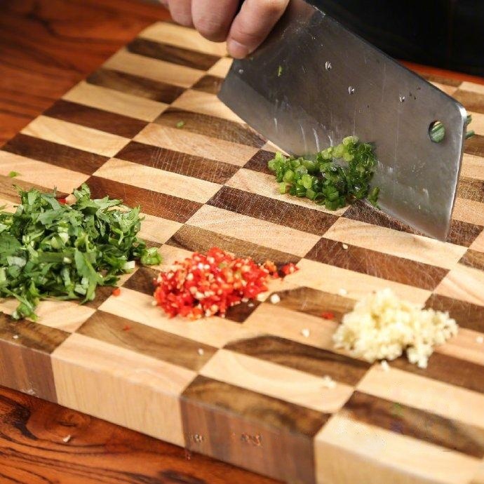 Wash your vegetables. Finely chop the scallion, cilantro, garlic cloves, and fresh chili peppers (Millet spicy/Thai chilies). Set these aside in a small bowl for the dipping sauce.