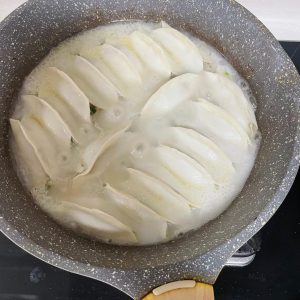 Give your slurry a quick whisk (starch settles) and pour it into the pan