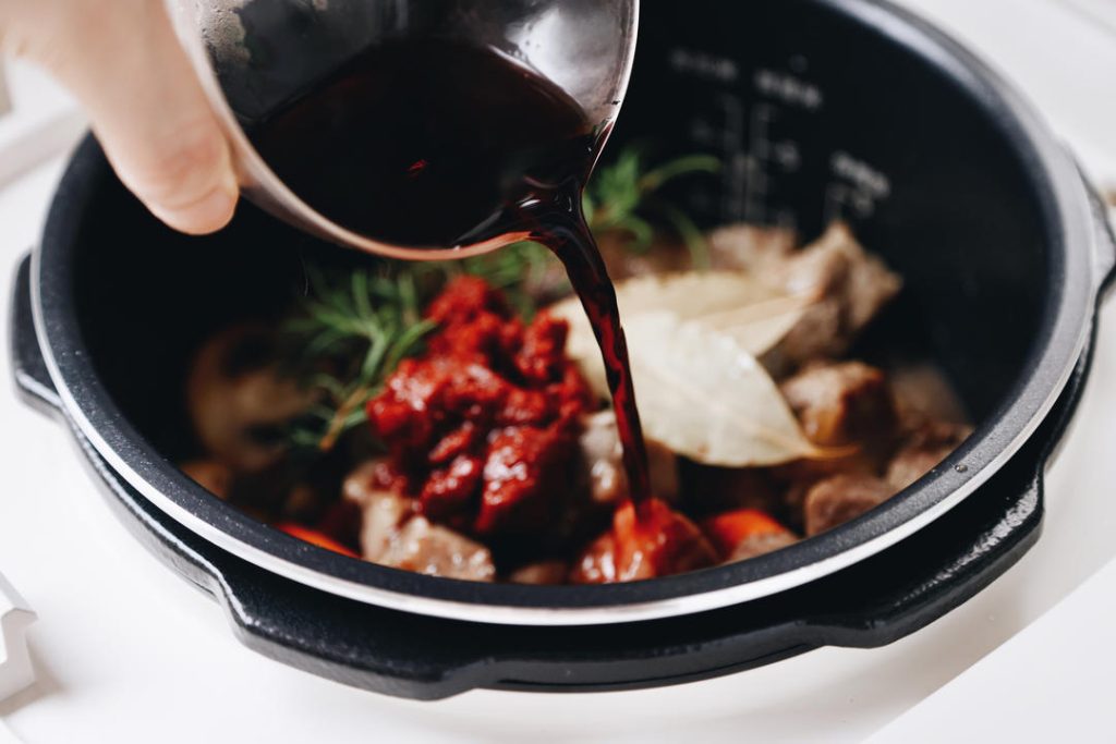 Deglaze and Fill Pour in the red wine.