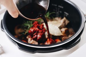 Deglaze and Fill Pour in the red wine.