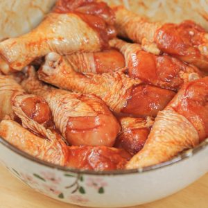 In a large bowl, combine the drumsticks with 2 porcelain spoons (approx 2 tbsp) of New Orleans marinade powder, 1/2 spoon of Dark Soy Sauce, and 5 spoons of water.