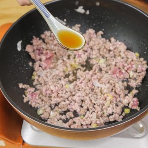 Pour in 1 tablespoon of Shaoxing Wine around the edges of the pan to deglaze and remove any gamey odor.