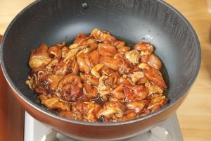 Turn the heat up to medium-high. Place the marinated chicken into the hot scallion oil.