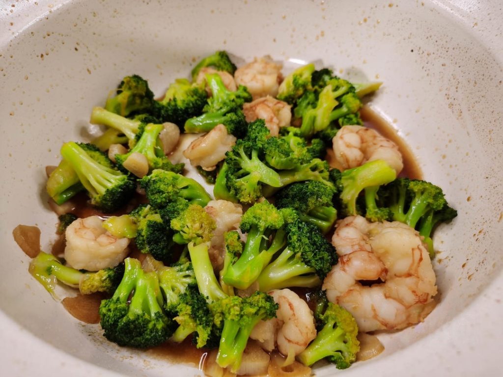 Add the blanched broccoli to the pan.