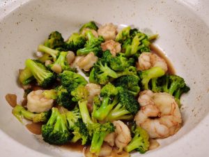 Add the blanched broccoli to the pan.