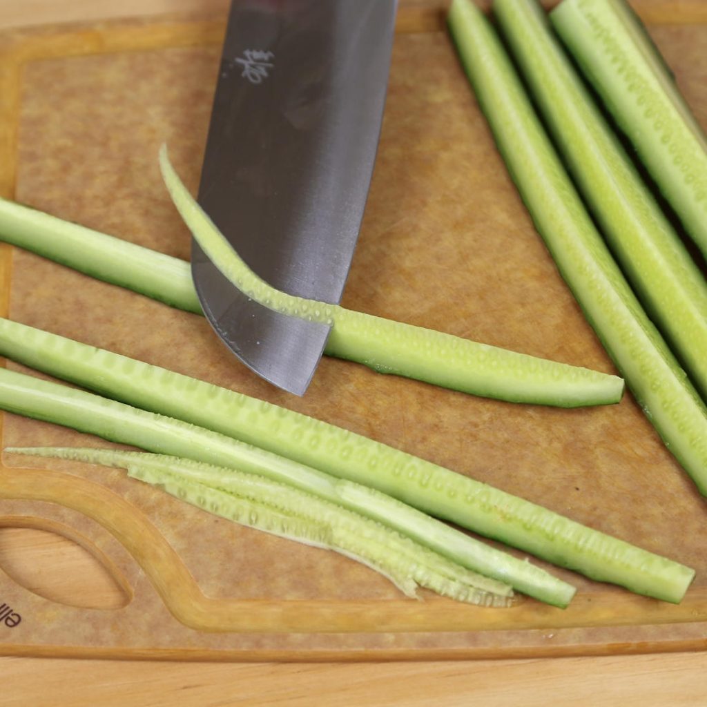 Wash your cucumbers thoroughly. Cut them into manageable sections (about the length of your index finger). Slice these sections into quarters lengthwise.