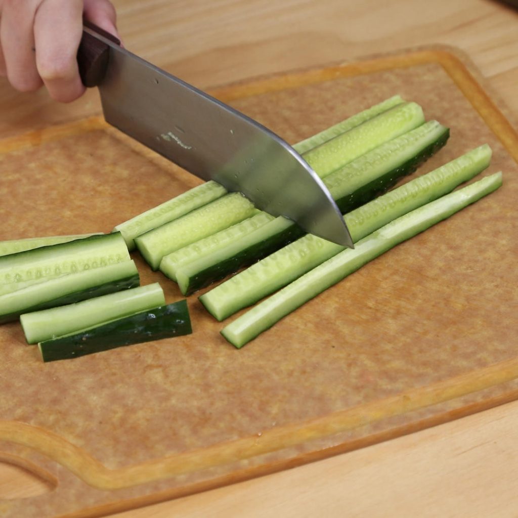 Wash your cucumbers thoroughly. Cut them into manageable sections (about the length of your index finger). Slice these sections into quarters lengthwise.