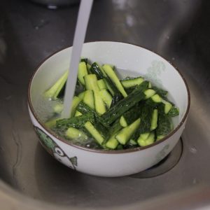 Place your cucumber strips in a large bowl. Add about 2 tablespoons of salt (or 1 "porcelain spoon" as we say in the family kitchen). Toss well to coat.