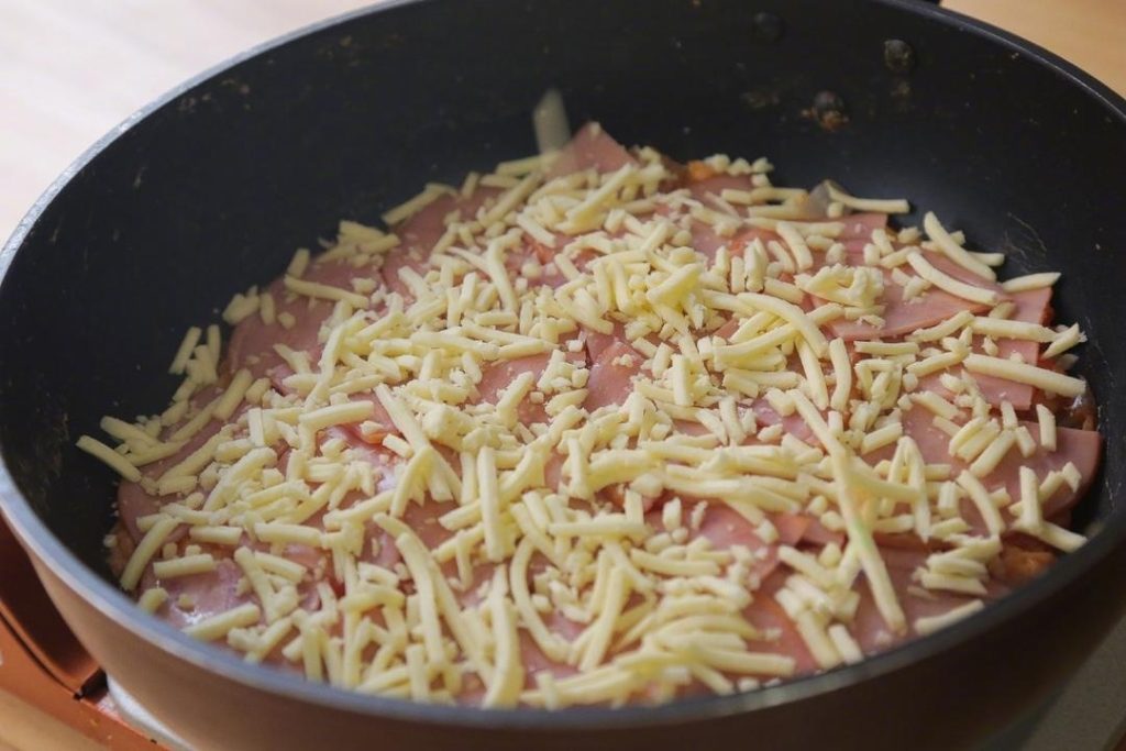 Sprinkle the mozzarella cheese generously over everything.