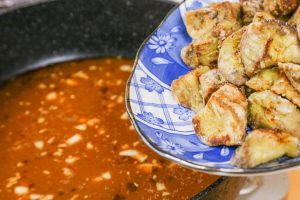 Combine Add the fried eggplant back into the pan. Toss quickly to coat every piece in the thick, glossy sauce.
