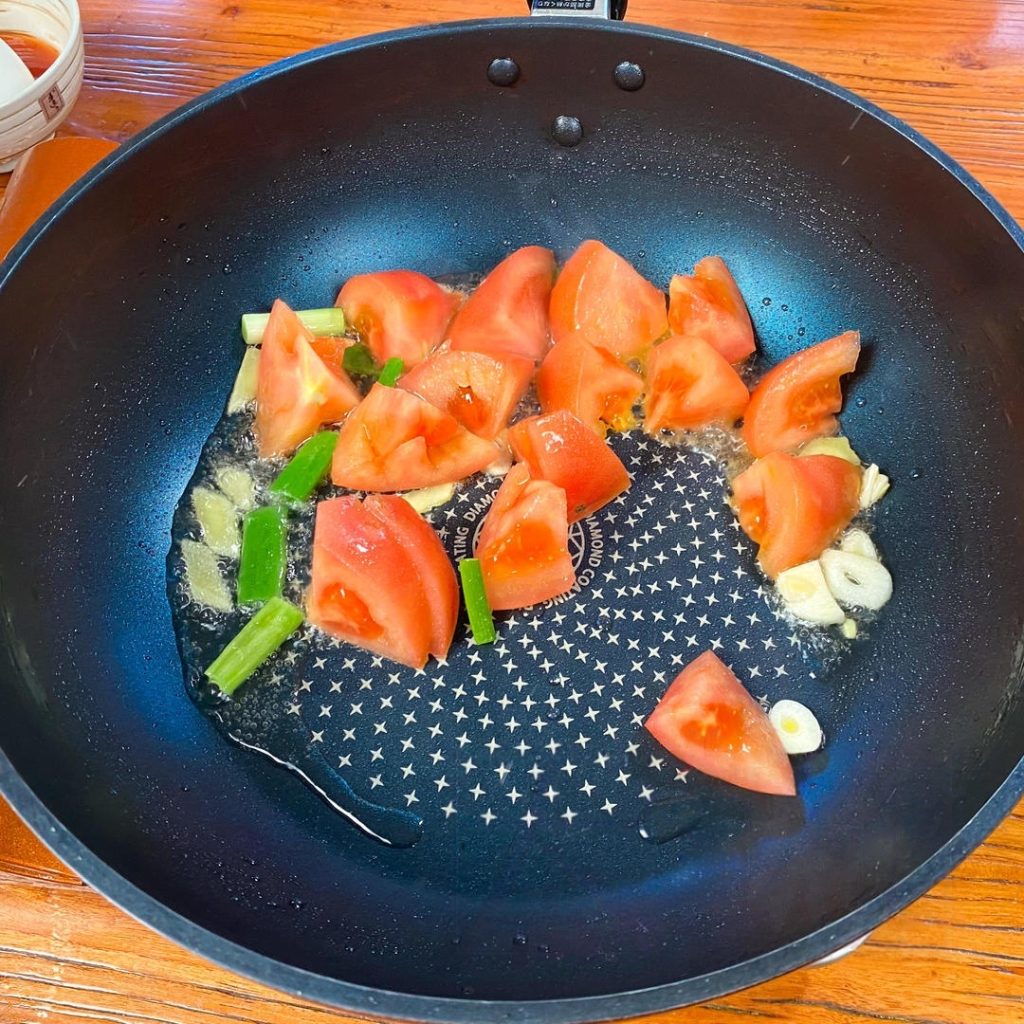 Cook Tomatoes: Add the chopped tomato chunks.