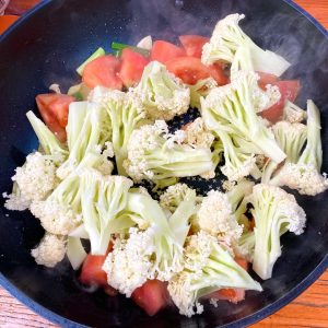 Stir-fry Cauliflower: Add the cauliflower florets to the pan.