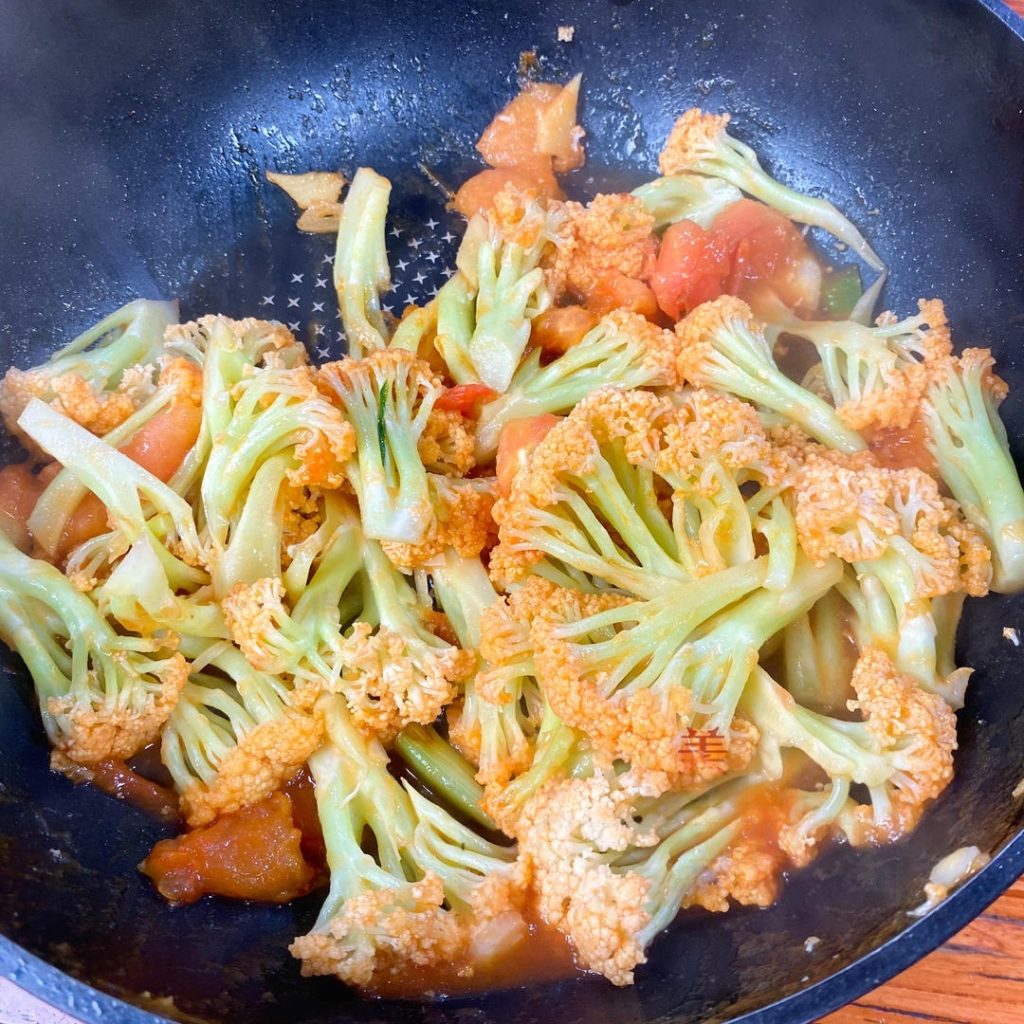 Finish: Continue to stir-fry for another 2 minutes. The sauce will bubble and coat the cauliflower, and the liquid will reduce slightly.