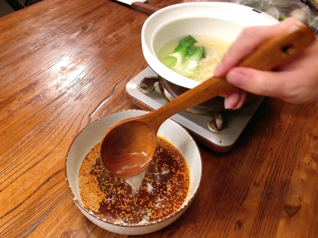 Before draining, ladle about 1.5 cups of the hot noodle cooking water (or plain boiling water) into your serving bowl with the sauce base. This creates your sour soup.
