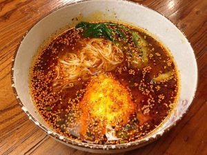 Transfer the cooked noodles and greens into the sour soup.