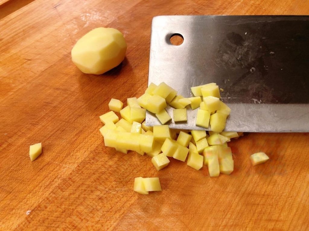 Dice 1 small potato and 1/2 carrot into small cubes (about 1cm).