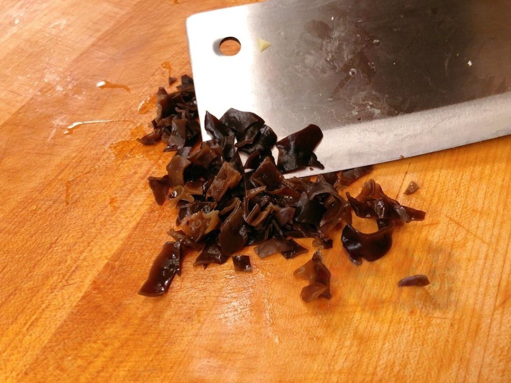 Rehydrate a small handful of dried wood ear mushrooms in boiling water for 5 minutes. Chop them into small dice.