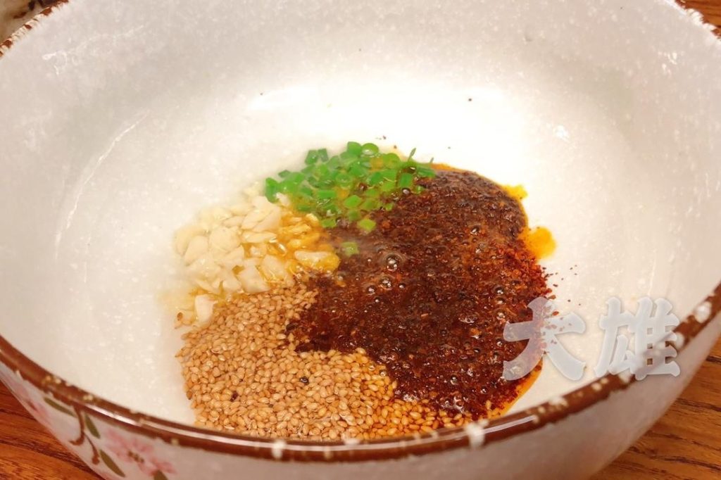 Carefully pour the hot oil over the chili and aromatics. It should sizzle aggressively and release a wonderful fragrance.