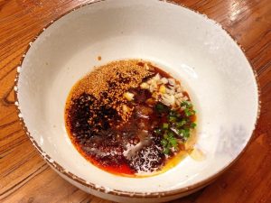 Immediately add the seasonings to the bowl: 1/2 tablespoon sugar, 1/3 tablespoon salt, 1 tablespoon light soy sauce, and 3 tablespoons Chinese Black Vinegar. Stir to combine.