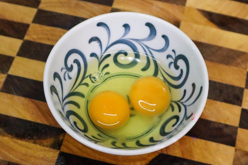 Crack the egg into a bowl but do not beat it yet.