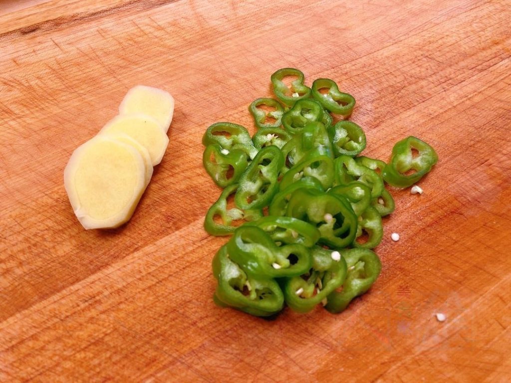 Aromatics: Slice the ginger (4-5 slices), peel the garlic cloves (keep whole), and slice your peppers into rings. Have your star anise and cinnamon ready.