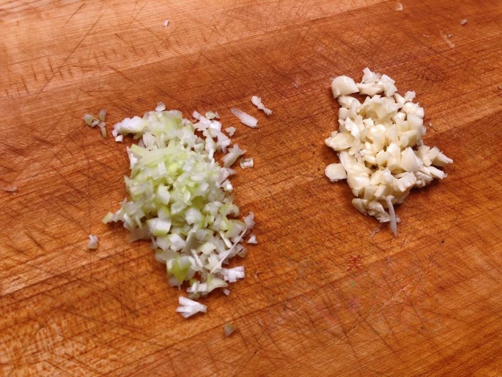 Finely mince the scallion (or leek) and garlic.