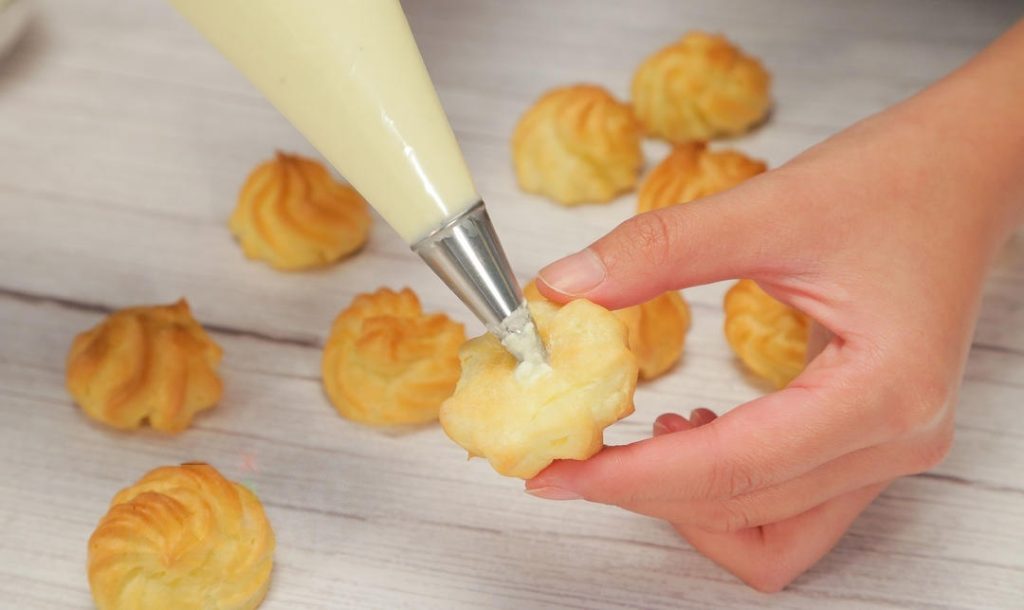 Fill: Once the puffs are completely cool, poke a hole in the bottom (or slice them in half horizontally). Pipe the cream generously inside.