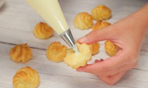 Fill: Once the puffs are completely cool, poke a hole in the bottom (or slice them in half horizontally). Pipe the cream generously inside.