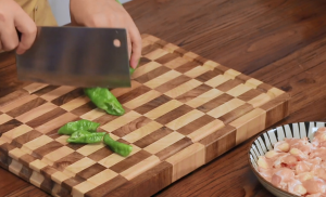 Slice the Long Green Peppers into rings and the Thai chilies into small dice.