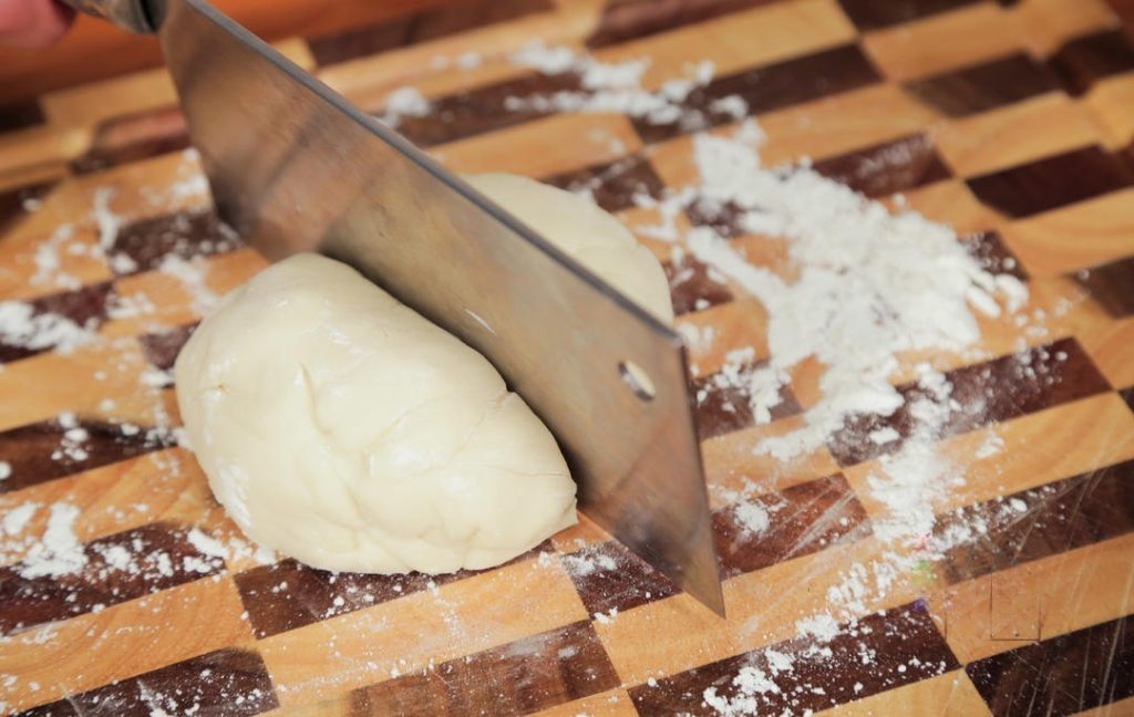 Shape the dough into a ball and wrap it tightly in plastic wrap. Let it rest at room temperature for 30 minutes.