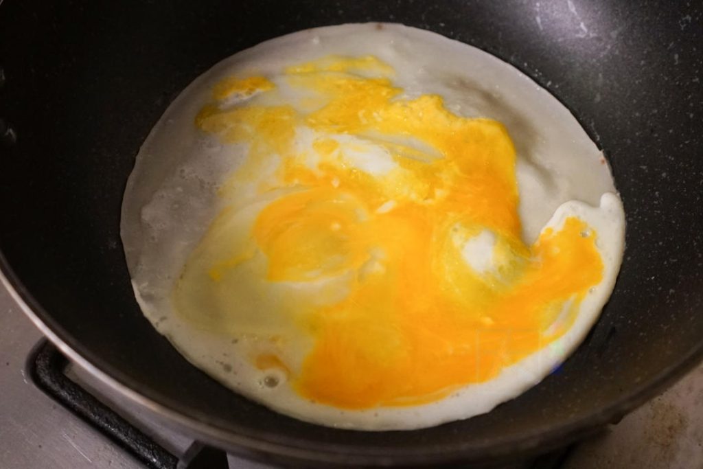 Turn the heat to low-medium. As the pan heats up, the batter will turn from opaque white to translucent/cooked.