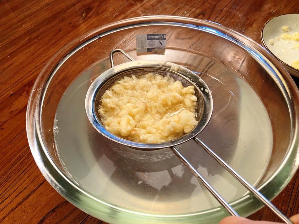 Wash the Garlic (Crucial Step): Take 2/3 of the minced garlic and rinse it in a fine-mesh sieve under cold water.