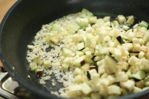 Cook the Eggplant Add the diced eggplant and the cooked meat back into the pan.