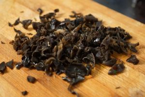 soak your wood ear mushrooms in warm water until soft. Wash them thoroughly and slice them into thin strips.