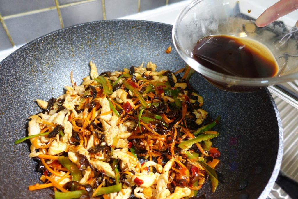 Give the sauce a quick stir (cornstarch settles) and pour it into the wok.