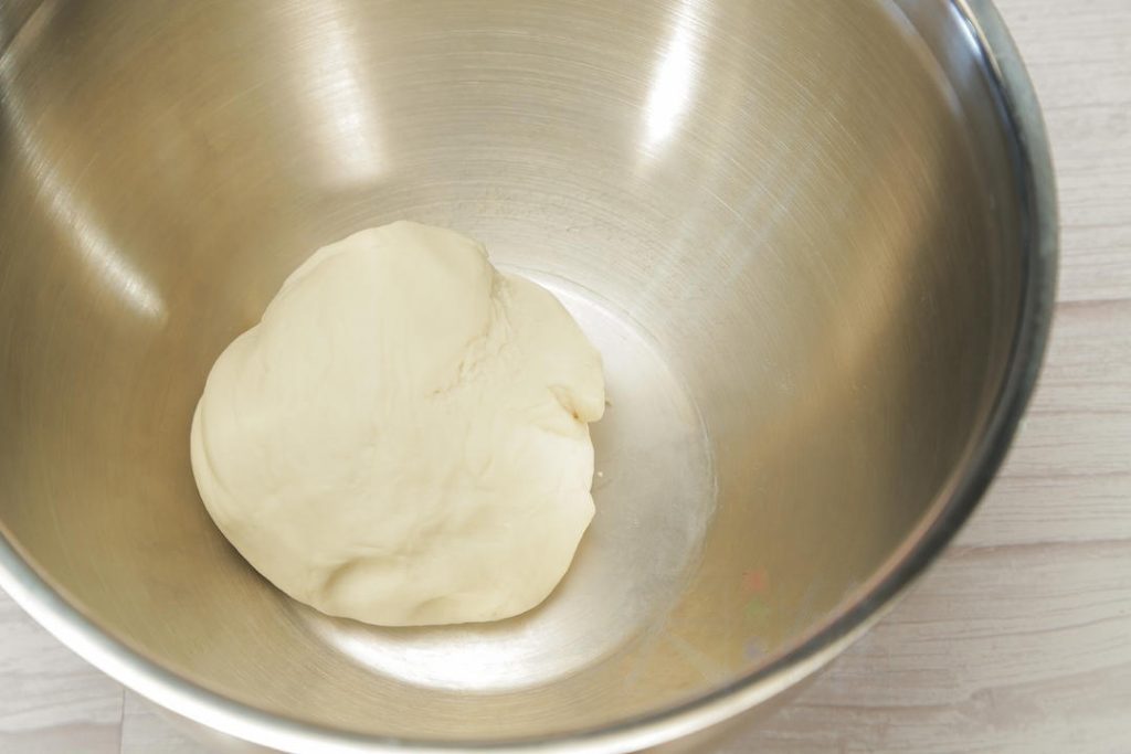 Knead: Add the vegetable oil to the dough. Knead by hand for about 10-15 minutes until the dough is smooth, elastic, and passes the "windowpane test" (you can stretch a small piece thin without it tearing).