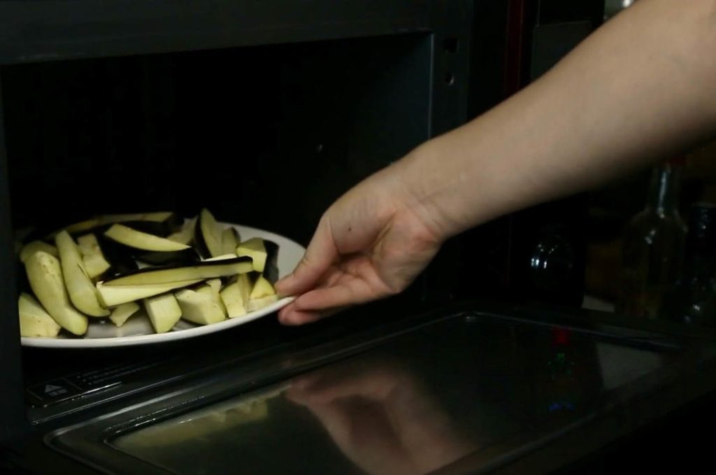 Prep the Eggplant: Cut 2 long eggplants into segments, then into strips. Spread them on a microwave-safe plate and microwave on high for 6-9 minutes until soft.
