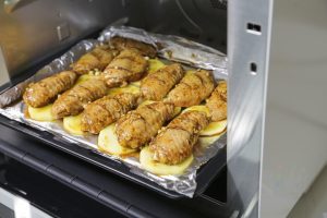 Place the tray in the preheated oven. Bake for 10 minutes. The wings will start to firm up and take on a little color.