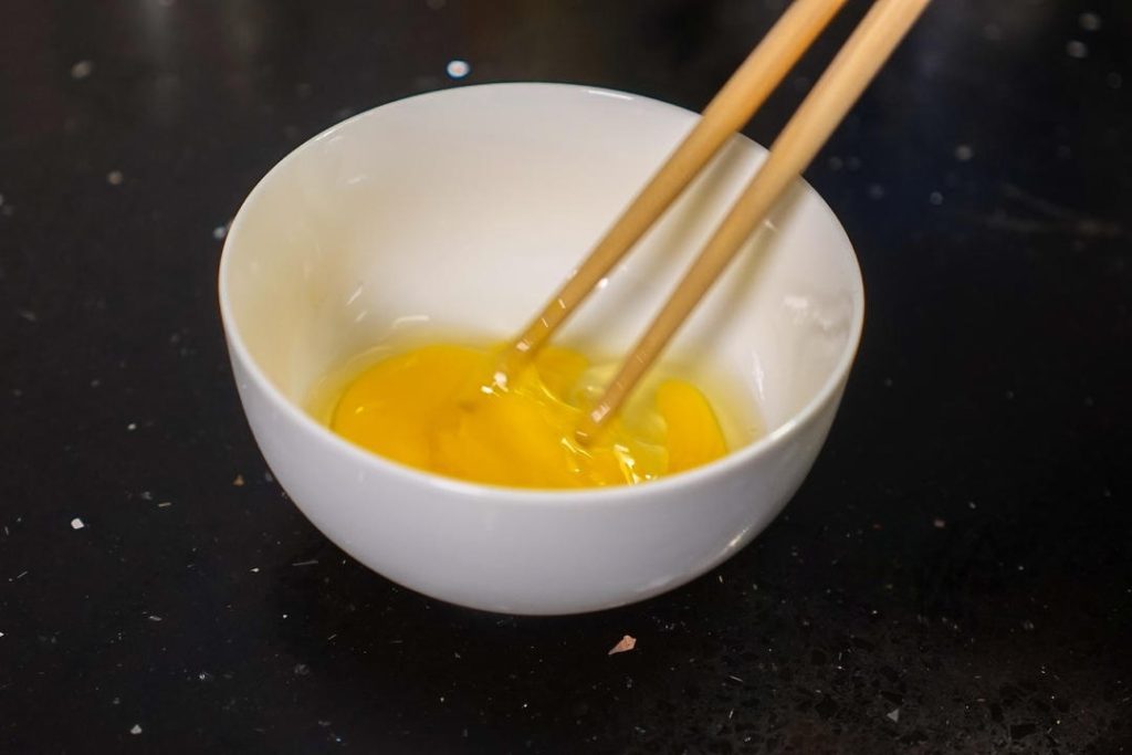 Crack the egg into a bowl and beat it well.