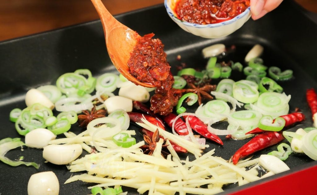 Release the Red Oil: Add the Doubanjiang and Sweet Bean Sauce. Stir-fry gently for 1-2 minutes until you see the oil turn a vibrant red. This step is crucial for removing the raw bean taste.
