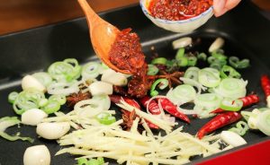 Release the Red Oil: Add the Doubanjiang and Sweet Bean Sauce. Stir-fry gently for 1-2 minutes until you see the oil turn a vibrant red. This step is crucial for removing the raw bean taste.