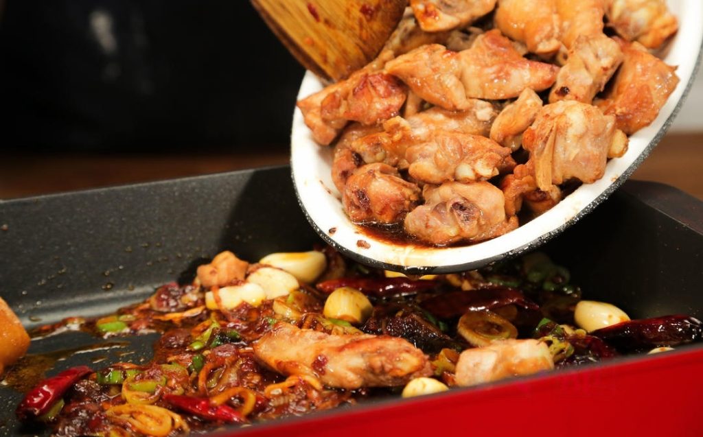 Braise the Chicken: Return the chicken to the pot. Add the second batch of seasonings: 3 tbsp light soy sauce, 1 tbsp dark soy sauce, and 2 tbsp sugar. Stir to coat. Pour in hot water until it just covers the chicken.