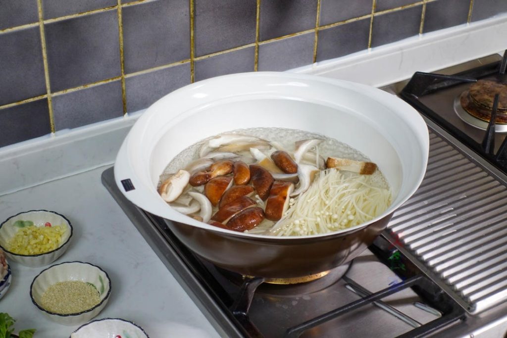 Create the Mushroom Broth Bring a pot of water to a boil. Add all the mushrooms (oyster, shiitake, enoki) at once.