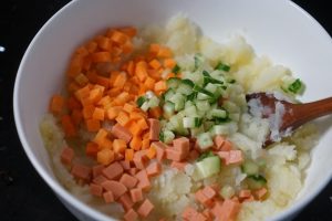 Add the diced carrots, cucumber, and ham to the mashed potato.