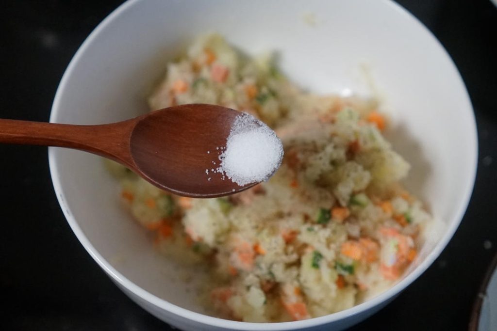 Add the salt, white pepper, and black pepper. Mix well.
