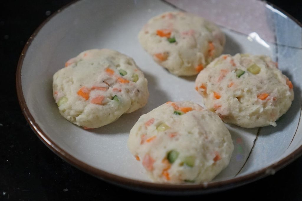 Divide the dough into equal-sized balls (about the size of a golf ball). Press them gently between your palms to form small, round patties.