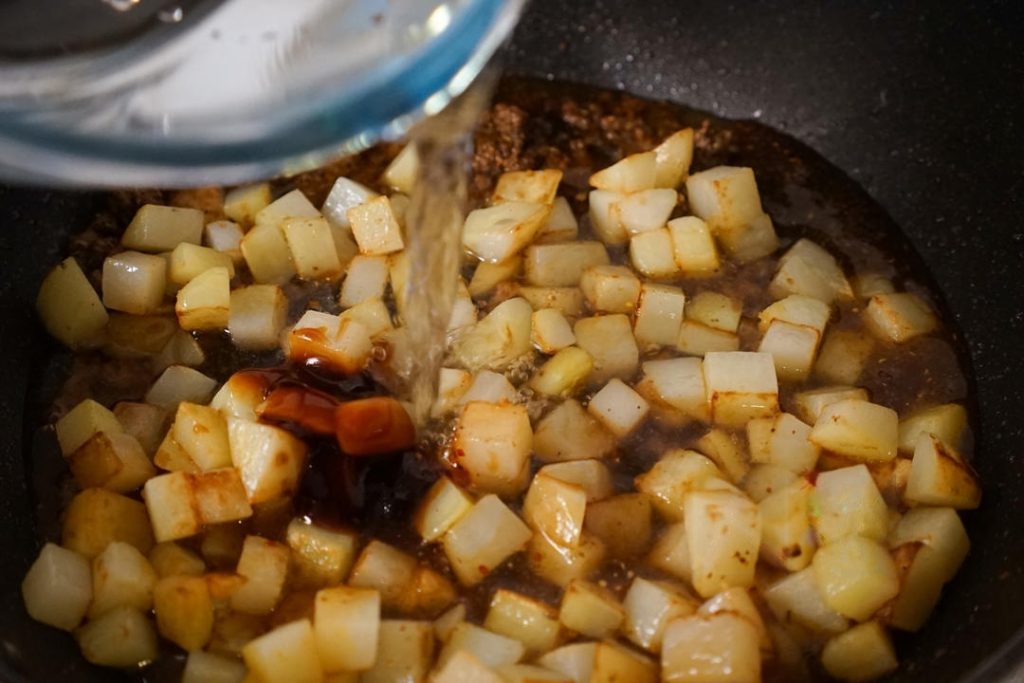 Pour in enough water to just cover the potatoes (about 1 cup).