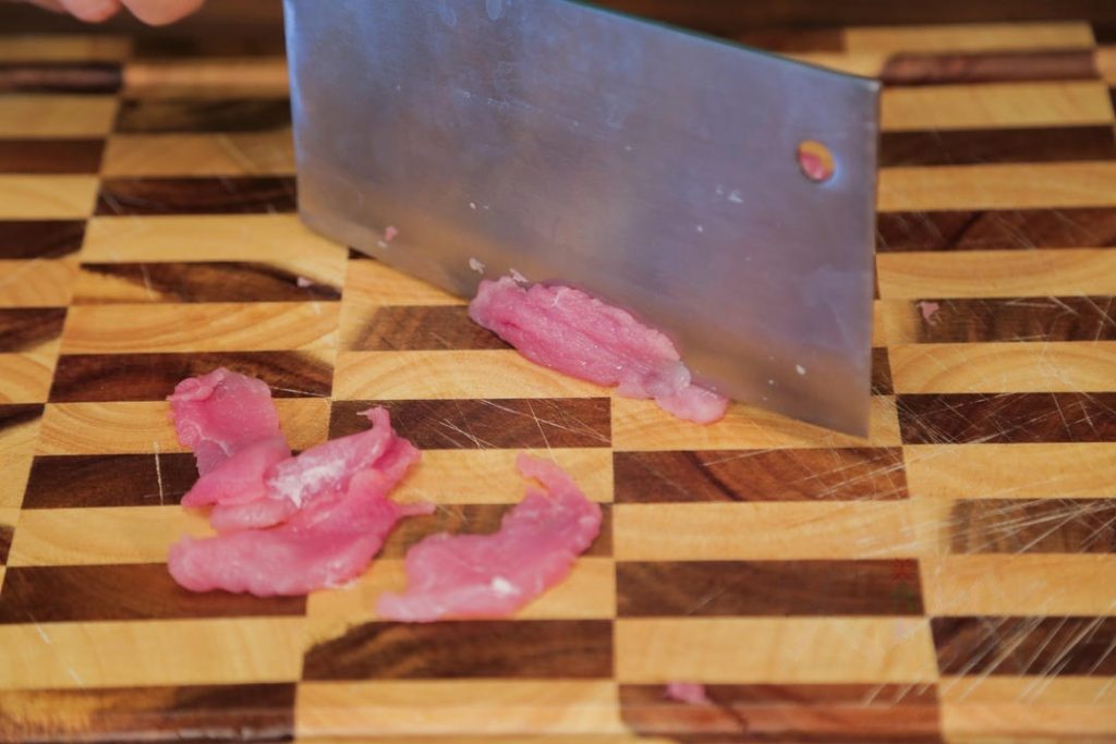 Slice the pork tenderloin against the grain into thin slices.